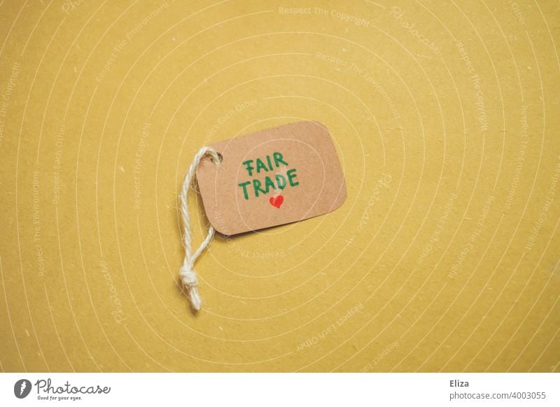 Label on which is written Fair Trade on a yellow background. Concept of responsible consumption. fair trade equitable trade Responsibility Social fair payment