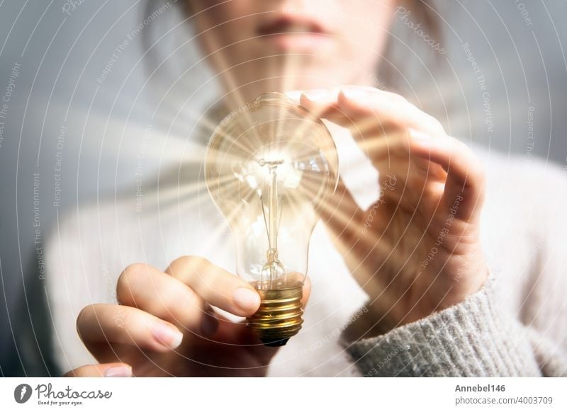 Female hand holding a shining light bulb, Great idea, innovation and inspiration, business concept background energy lamp bright electricity creativity