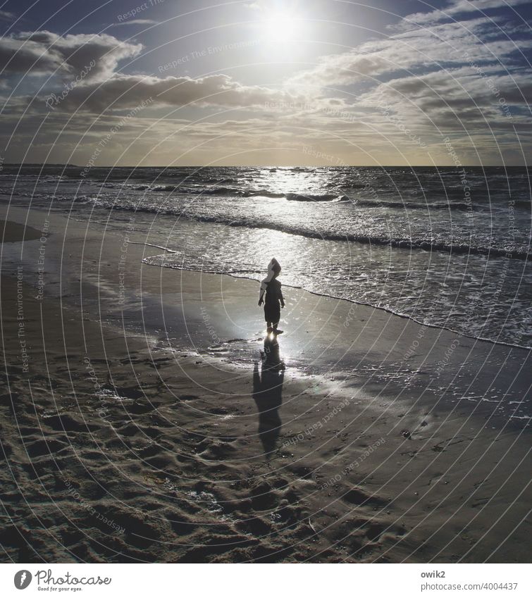 Youth philosophizes Beach luminescent Sun Back-light Water Sand Child Boy (child) Silhouette Shadow Contrast Stand Marvel 3-4 years Waves Lonely