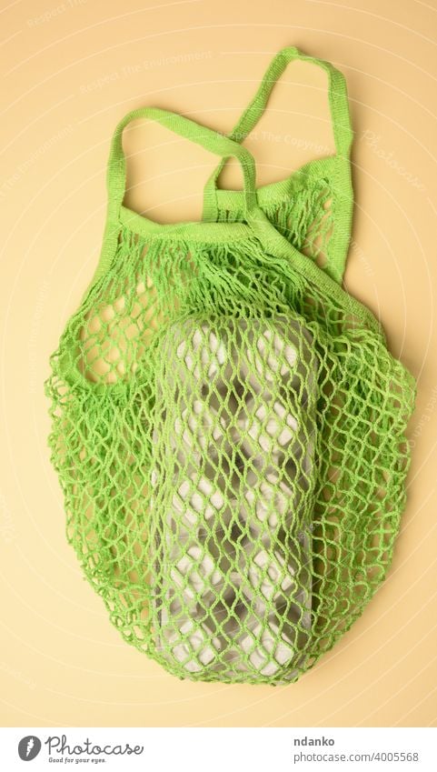 reusable green textile shopping bag with egg cartons on a green background mesh bag natural nobody organic package paper recycle shopper sustainable top tote