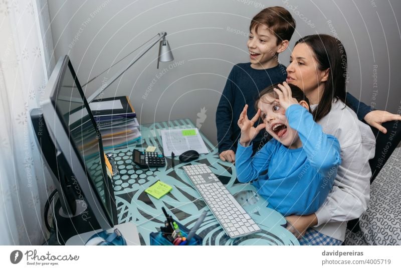 Family talking on video call while the girl grimaces mother children fun grimacing computer coronavirus quarantine family covid-19 video conference funny