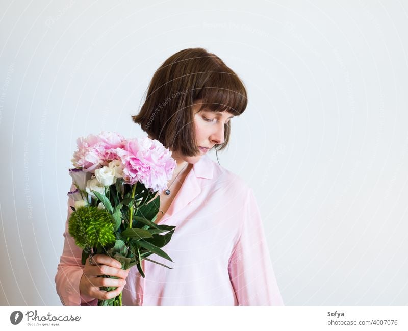 Young woman holding beautiful pastel peony bouquet mother day florist mothers day flowers spring face pink lifestyle womens day smile expression bunch fashion