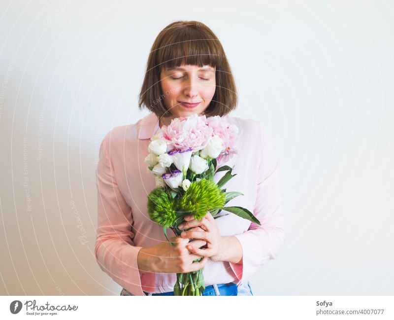 Young woman holding beautiful pastel peony bouquet flowers mother day spring mothers day authentic face pink lifestyle womens day happy smile expression florist