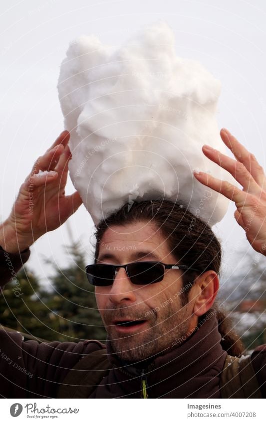 Portrait of a bearded man with dark glasses balancing a giant snowball on his head balance Facial hair Eyeglasses Ice adult Happiness Frozen Sky hobby Head