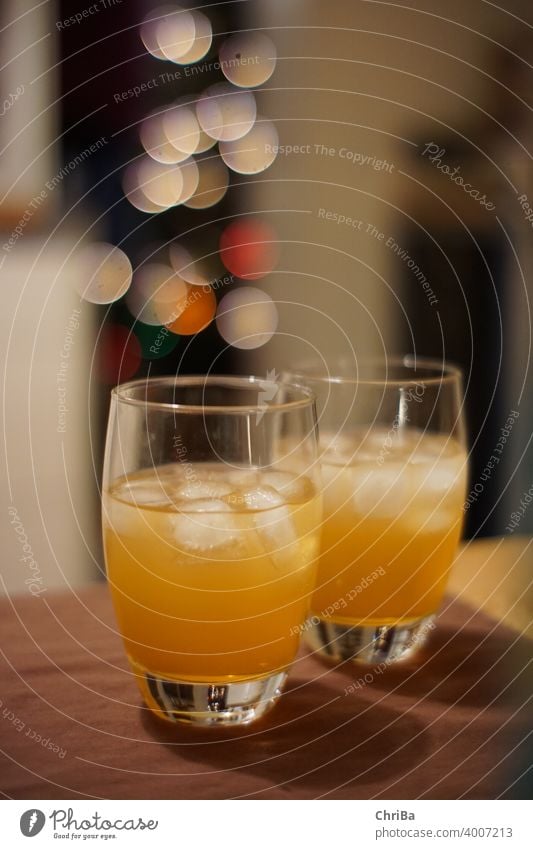 Drinks with ice and lights bokeh drink Ice Ice cube Beverage Alcoholic drinks Glasses Toast Orange Bitter herbs Christmas Festive Glamor glitter focus gradient
