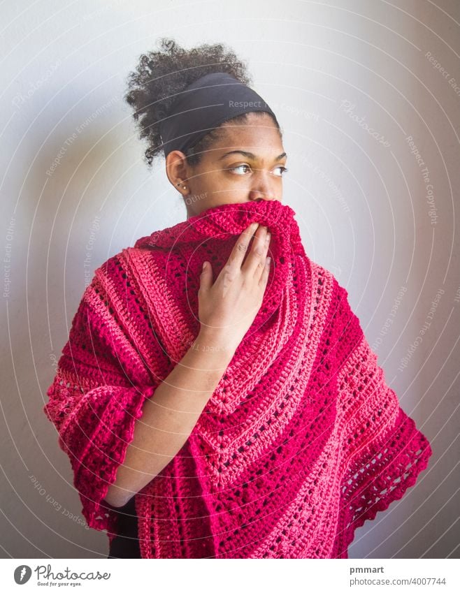 Young girl with red and pink poncho or shawl coasters gorgeous centerpiece colorful handcrafted light green knitted model brazilian smiling happy young