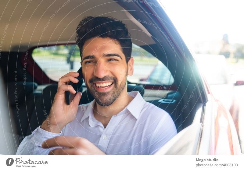 Businessman talking on phone in car. businessman mobile taxi transportation cab male portrait adult professional auto going to work wireless entrepreneur