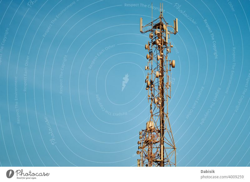 Communication tower with antennas against blue sky cell broadcast radio telecommunication network mobile technology wireless transmitter metal phone frequency