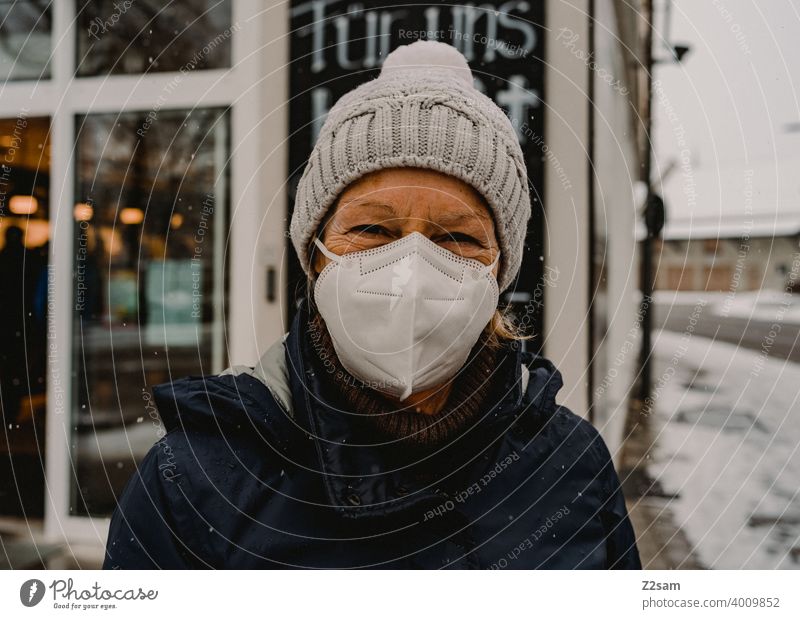Woman with mask in front of shop corona pandemic Mask COVID Risk of infection coronavirus covid-19 Protection prevention Retail sector business Attachment