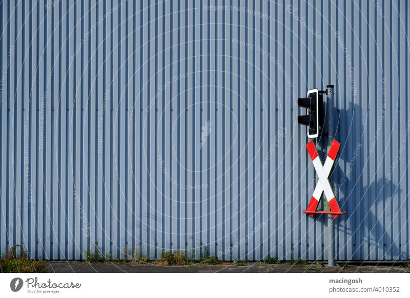 Industrial area with level crossing Corrugated sheet iron Corrugated iron wall Railroad crossing St. Andrew's Cross Exterior shot Facade Metal Industrial plant