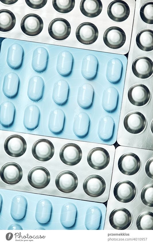 Tablets and capsules pill in blister packaging arranged in row. Medicines - tablets, pills in blister pack, medications drugs medicine antibiotic concept