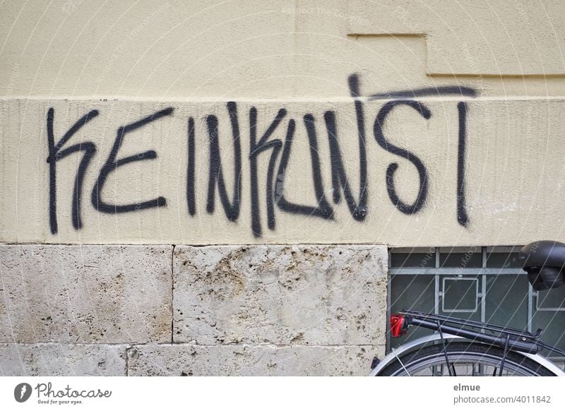 "KEINKUNST" someone has sprayed in large black letters on the facade of the house / Sprayer / Graffito No art Facade Bicycle cabaret house facade sprayer Word
