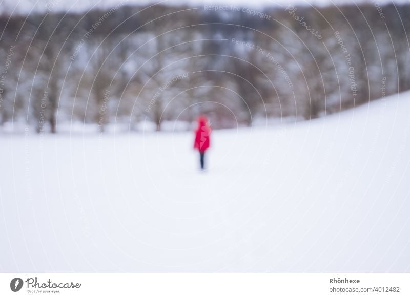A "ghost" in a red jacket photographed out of focus during a winter walk blurriness Human being Colour photo Exterior shot Day Winter Snow White Winter light