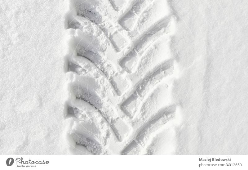 Picture of heavy duty vehicle tire track in snow. winter cold nobody white road highway background transport outdoors pattern weather imprint season danger