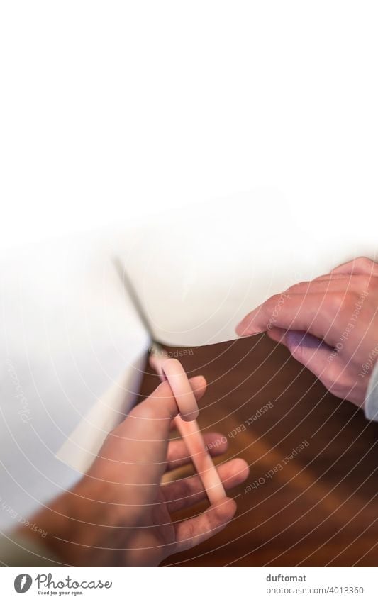 Bird's eye view of hands cutting a large white paper with scissors. Hand human hand Claw divide Paper White disconnect Fingers Close-up Man Skin Adults