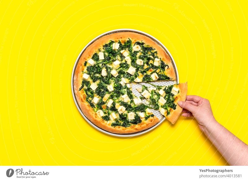 Vegetarian pizza isolated on a yellow background. Woman taking a slice of pizza. above view baked comfort food cooked crust cuisine cut out delicious dinner
