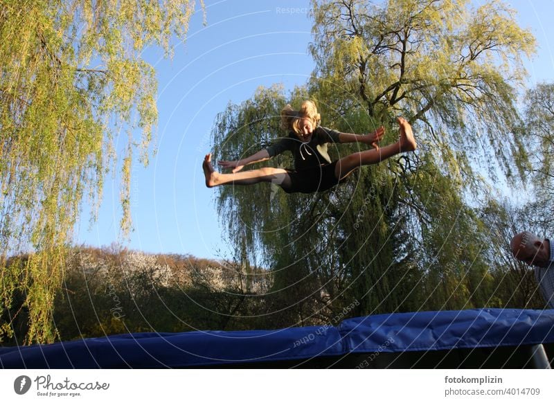 Teen jumps on a trampoline Trampoline Hop Jumping power Gymnastics Acrobatic Fitness Joy Flexible Youth (Young adults) Movement Joie de vivre (Vitality) Sports