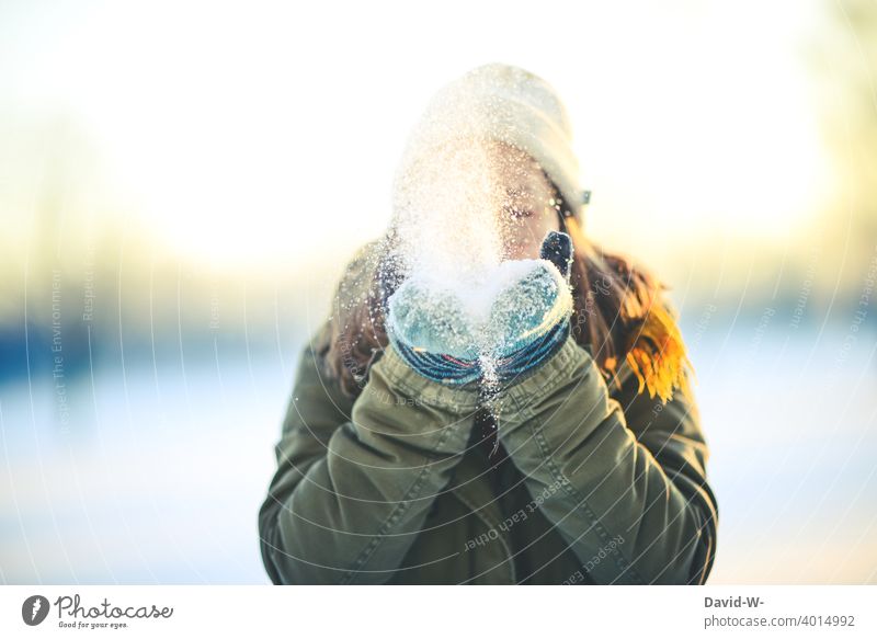a beautiful winter day - woman blows snow from her hands into the air Winter's day Snow Winter mood December fun Joy Woman onset of winter Sunlight