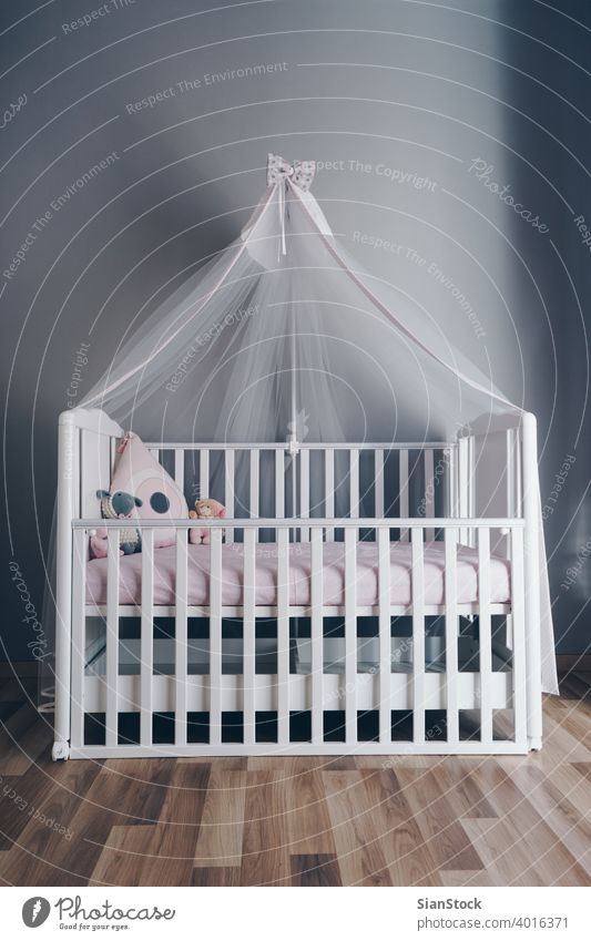 Shot of a modern grey nursery room baby bed crib interior white cot child home wooden design furniture bedroom infant background isolated kid newborn care empty
