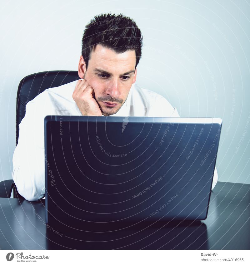 Man at laptop home office Earnest concentrated Computer work Online labour Workplace