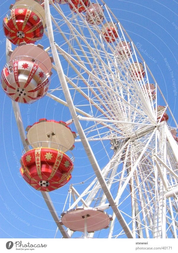 Under the wheel Ferris wheel Fairs & Carnivals Rotate Round Vantage point Romance Leisure and hobbies Joy Feasts & Celebrations Tall Sky Flying