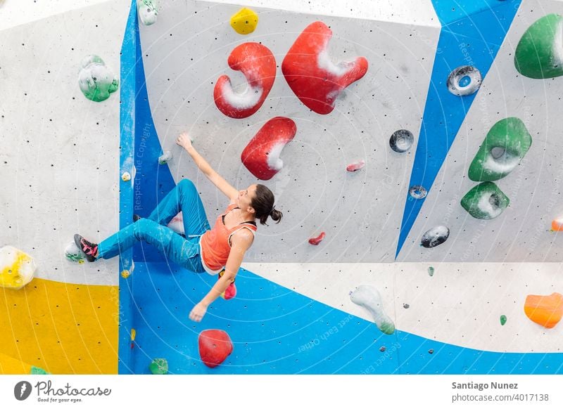 Rock climber woman looking at smartphone. climbing rock climbing copy space unrecognizable indoor workout wall gym young training sport leisure active safety