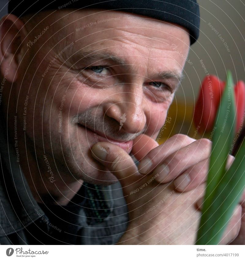 The serenity Man Cap Looking Smiling Tulip Flower Face portrait inquisitorial contented grin amused amusing Cheerful Serenity