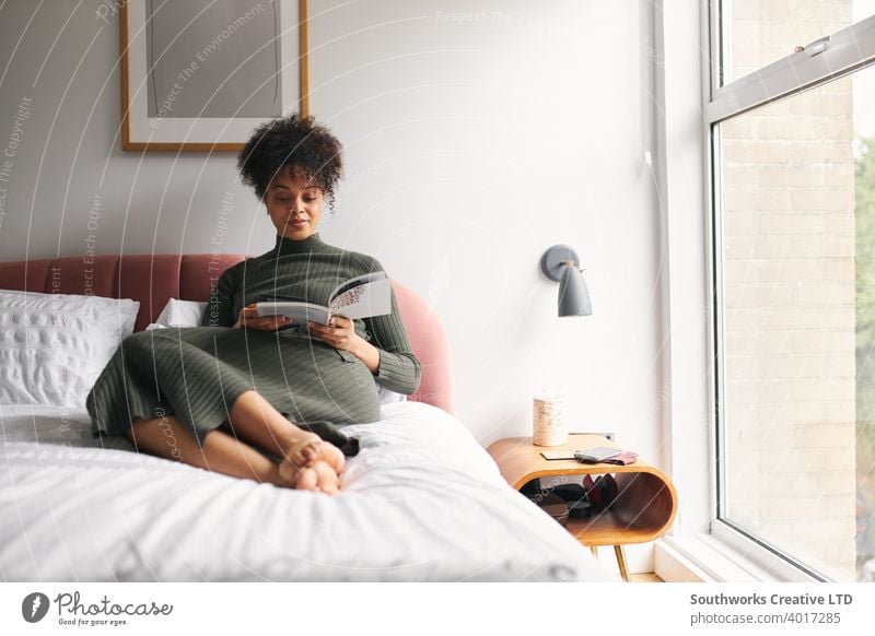 Young Woman Lying And Relaxing On Bed At Home Reading Book woman at home relaxed relaxing reading book studying learning teaching self help technology free bed