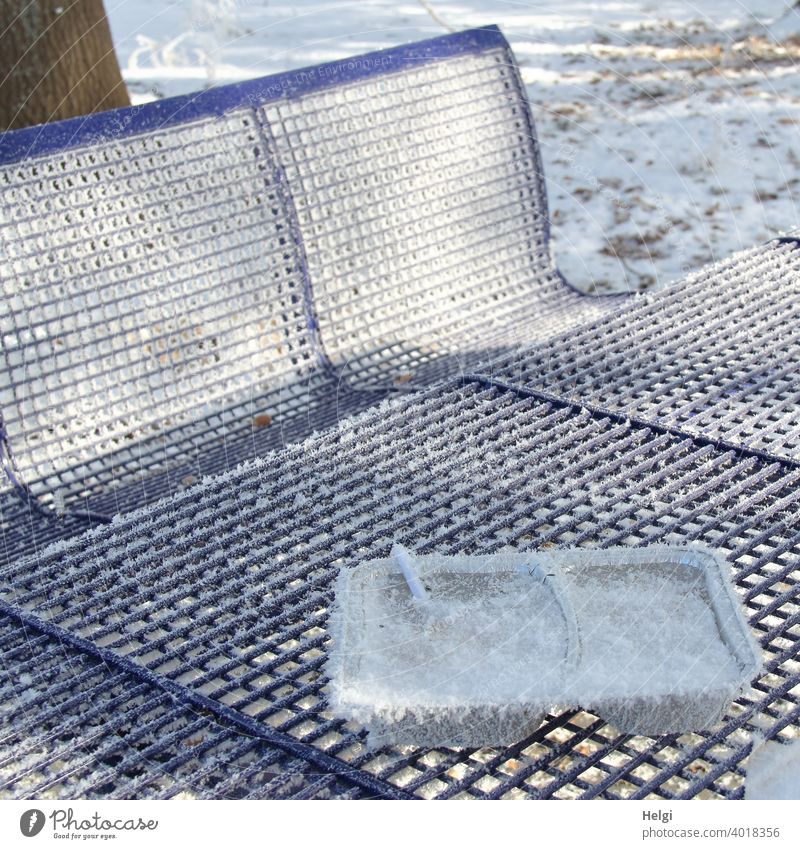 eating out - leftover wrapping of a meal covered with hoarfrost and table and benches at a rest area Trash Residual waste Packaging Meal Resting place Table