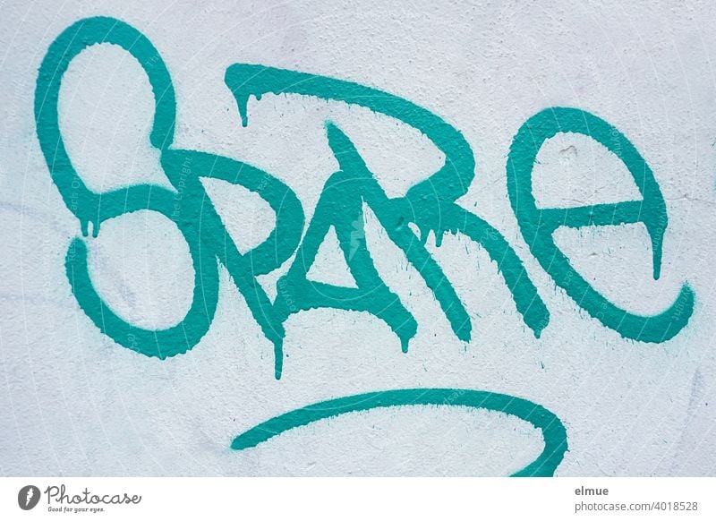 "SPARE" is written in gradient capital letters in cyan on a house wall / shy / spare save Schonen sprayer pass writing English Daub Letters (alphabet) Graffiti