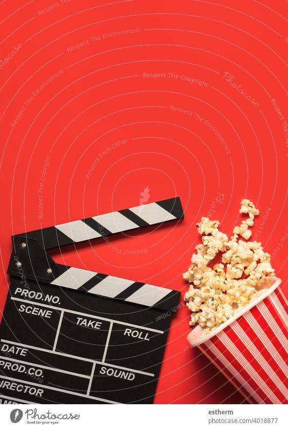 movie clapperboard with popcorn and space for text.Cinema concept background cinema film clapboard filmstrip chalkboard popcorn box directing objects television