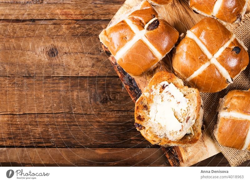 Easter Breakfast with Hot Cross Buns hot cross bun easter bread butter food traditional sweet fresh white holiday wooden celebration cake baked treat view