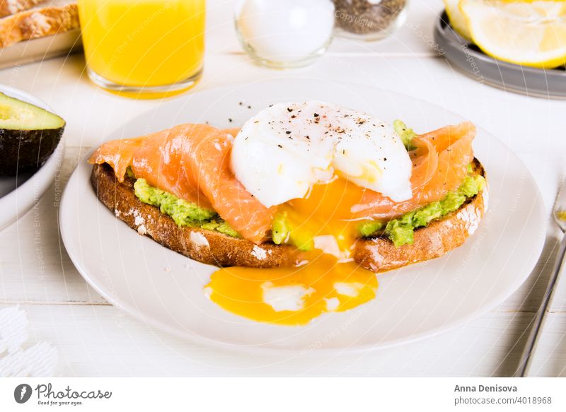 Wholemeal Bread Toast, smashed Avocado, Salmon and Poached Egg Breakfast Boiled Green Detox Diet Lemon Clementine Fish Juice Glass Cup Benedict Lunch Organic