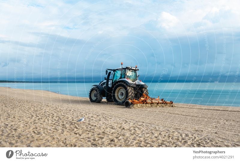 Beach on Rugen Island, Germany. Tractor grooming  sand on the beach at Baltic Sea Pomeranian coast Sassnitz baltic sea beach scenery clean cleaning coastline