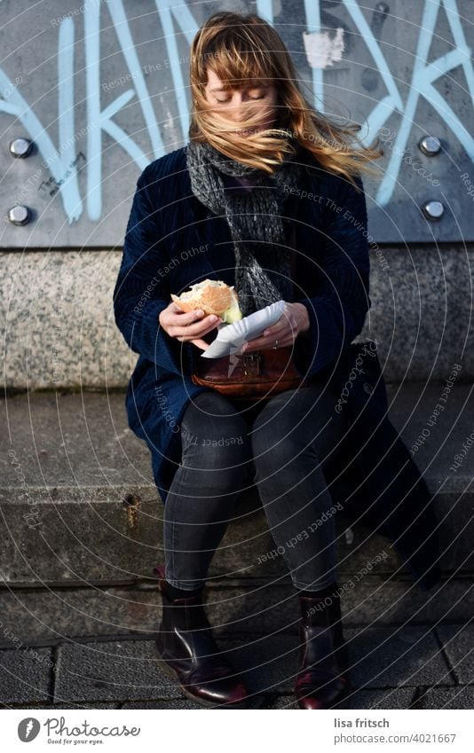 ..first a fish sandwich, if the wind allows! Woman Young woman 25-29 years Blonde long hair Winter Scarf Fish roll Wind windy Blown away Adults naturally pretty