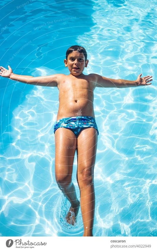 Young boy jumping on a pool action active activity blue child childhood cute dive drop emotion excited explosion fun funny game glasses happiness happy holiday