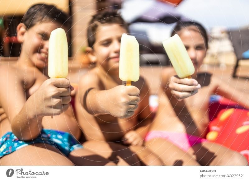 Close-up of three ice creams with three children out of focus active adorable boy cheerful childhood close-up cute defocused eating enjoy enjoying enjoyment