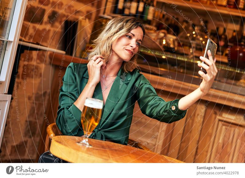 Woman taking a selfie at a bar. couple adult woman happy female restaurant lifestyle caucasian beautiful happiness drink smile fun love joy celebration dating