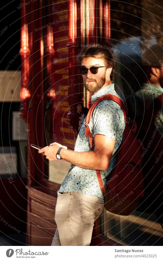 Man looking at his phone on the streets. adult happy lifestyle caucasian happiness smile fun love joy leisure cheerful laughing date smiling enjoyment 30s