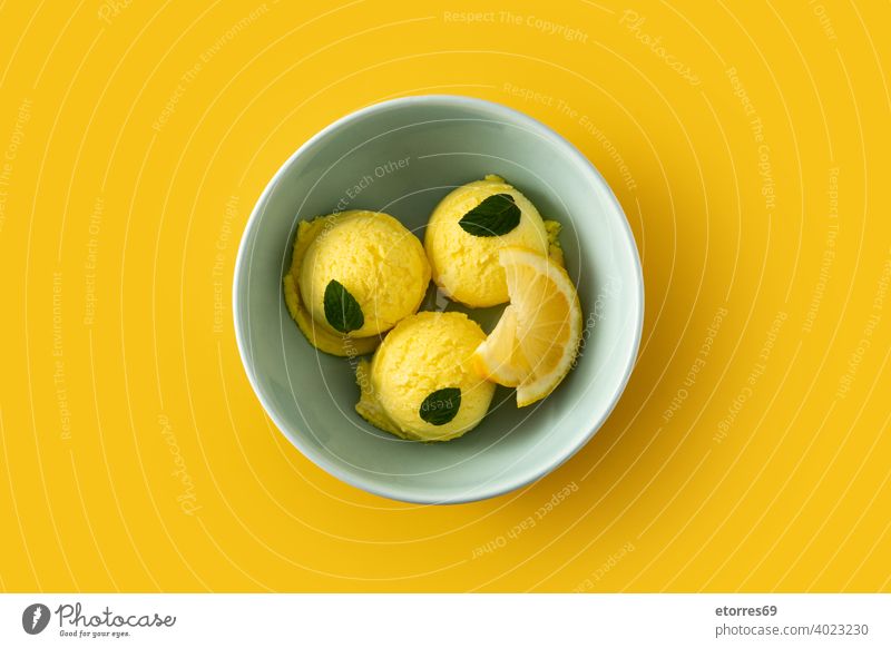 Lemon ice cream scoop decorated with mint leaves in bowl cold creamy dairy delicious dessert food freeze iced isolated lemon refreshment snack summer sweet