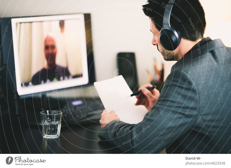 Video conferencing on the computer Online meeting communication home office replace Discussion Man Computer Headset laptop Screen zoom Workplace Desk chat