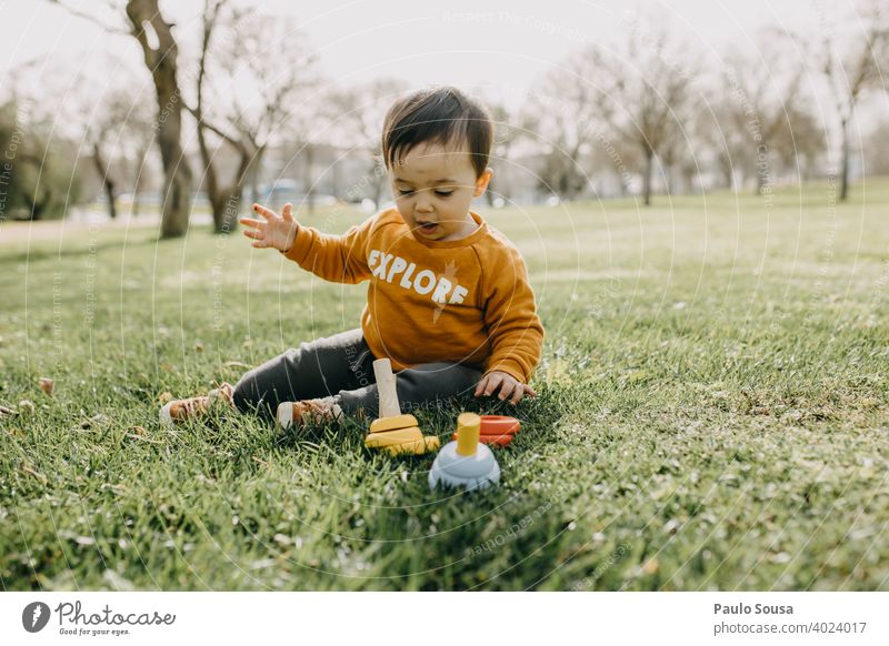 Toddler playing with woodem toys at park Spring outdoors Park Playing Kindergarten Exterior shot Child Infancy Joy Colour photo Playground Human being Day Happy