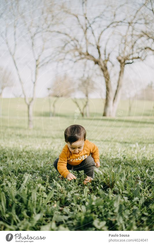 Child playing in the park Park Caucasian 1 - 3 years Colour photo Infancy Human being Toddler Day Exterior shot Lifestyle Joy Cute Grass Spring Authentic