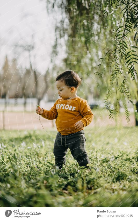 Child playing outdoors Spring Spring fever explore childhood Garden Flower Happy Happiness Colour photo Infancy Day Joy Nature Exterior shot spring Lifestyle