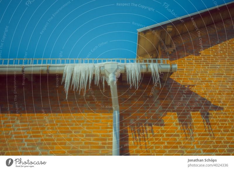 Icicles on the gutter on brick house facade Architecture Brick Brick-built house Brick House Settlement Roof roof edge Eaves Ice Downspout Worm's-eye view