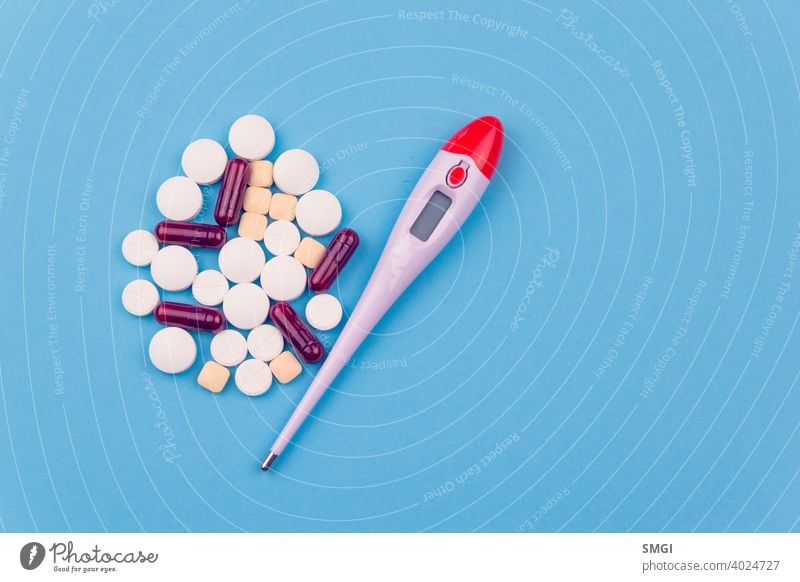 Overhead shot of several pills and a thermometer. Concept of drugs for the treatment of diseases, especially against Covid-19 tablet medicine medical