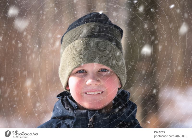 Young boy in the snow with a knitted hat natural wool clothes pretty environment closeup snowflake smiling lifestyle weather one freeze outdoors frost holiday
