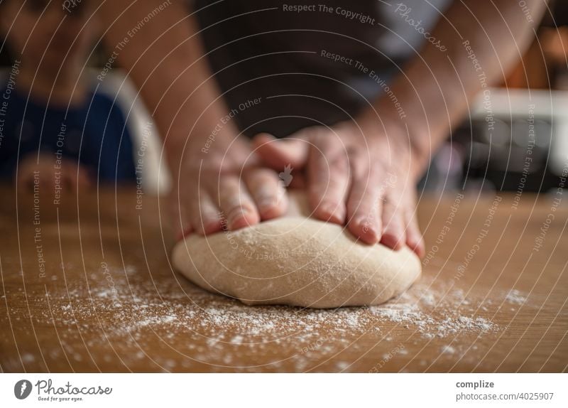 A dough is kneaded on a kitchen table Dough pizza dough Kitchen Kitchen Table Flour dust Self-made Baking Bakery Baked goods Bread bread dough hands Fist Child