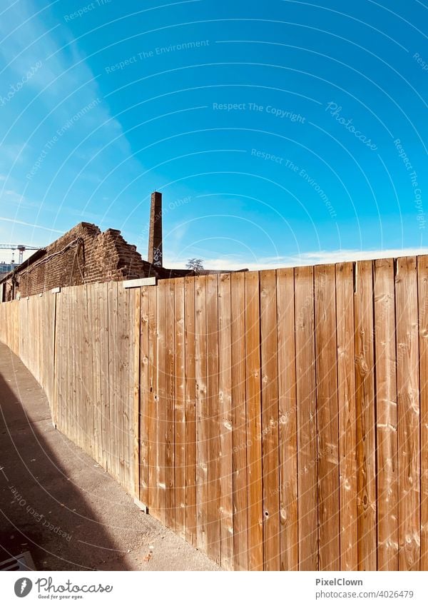 Construction fence in front of an industrial site Fence Wood Wooden board Wall (building) Deserted Wooden wall Brown, Facade Structures and shapes Colour photo