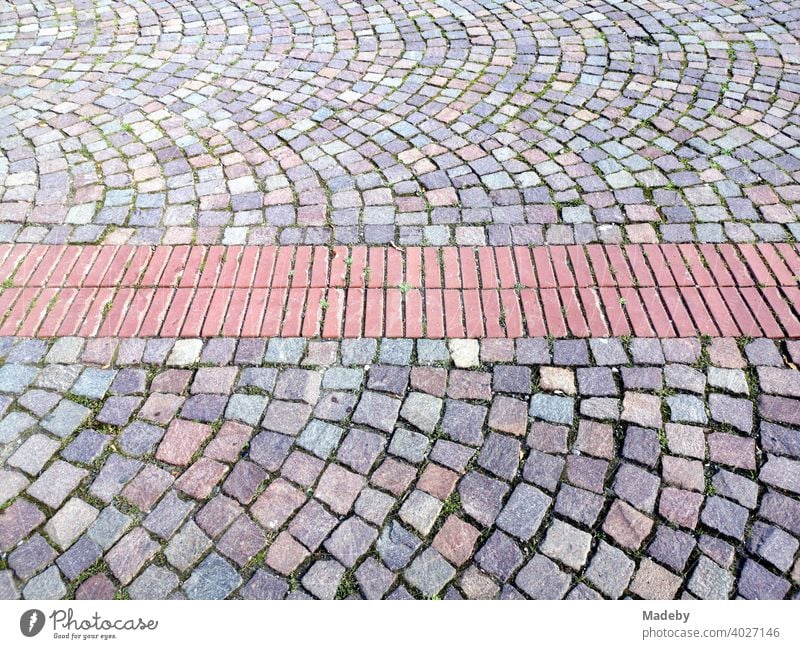 Red bricks embedded in colorful cobblestones on a square in Bad Salzuflen near Herford in East Westphalia-Lippe, Germany pavement Cobblestones paving